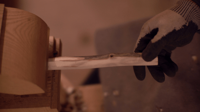 Wood being shaped with a lathe