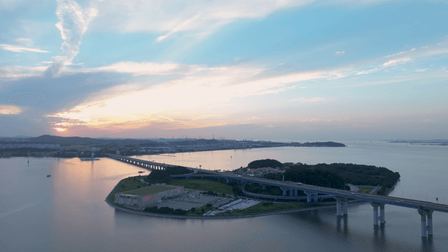 Bridge over a sea at sunset