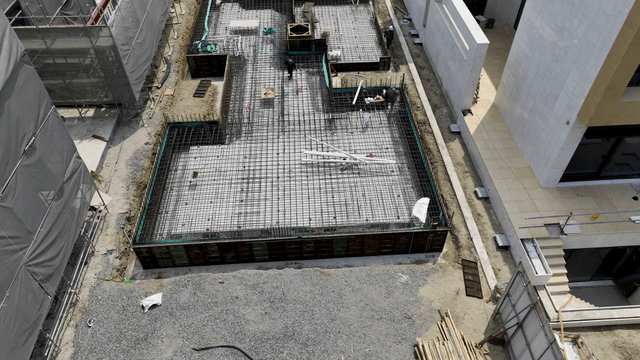 Construction site with workers and buildings