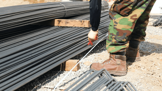 Construction worker handling rebar