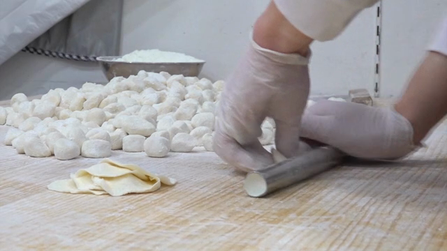 Rolling dough in a kitchen with flour