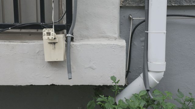 Exterior wall with pipes and cables