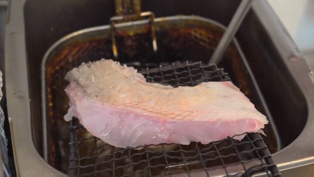 Boiling oil poured over fish