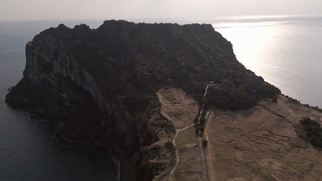A majestic coastal mountain with sunlight