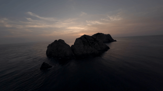 Sunset over rocky coastline and sea