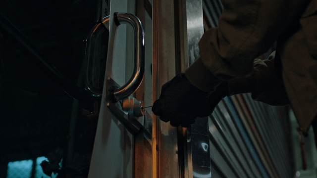 A person attempting to pick a lock