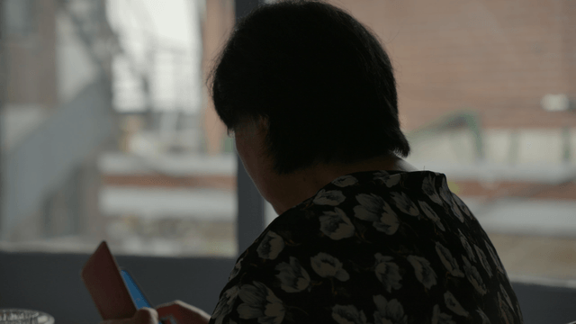 A person using a smarphone indoors