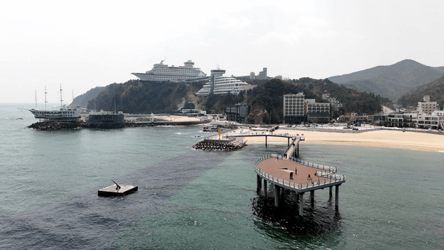 Coastal town with a pier and cruise ship