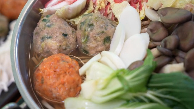A pot of Korean hot pot with vegetables and meat