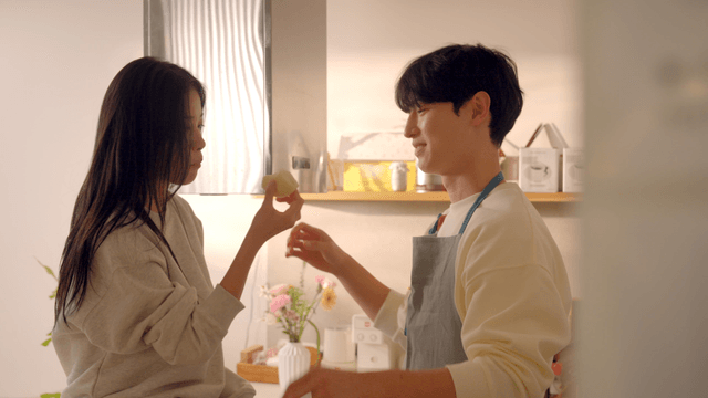 Couple enjoying bread and coffee in kitchen