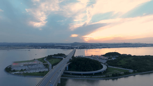 Bridge over a sea at sunset