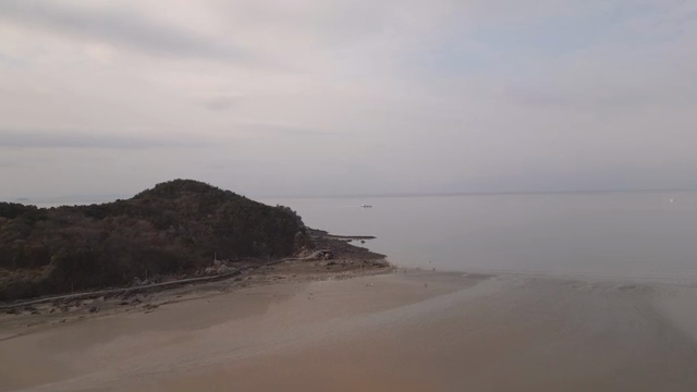 A serene beach with distant hills
