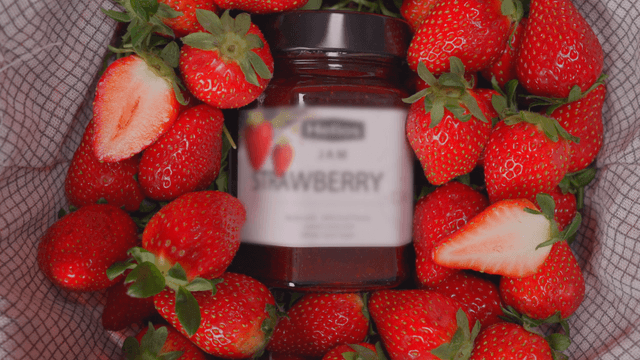 Fresh strawberries and strawberry jam jar
