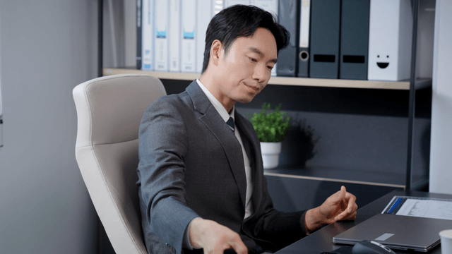 Man in a suit working at his desk