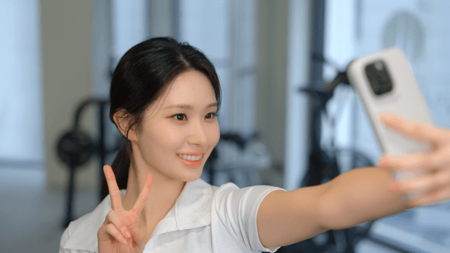 Young woman taking a selfie in a gym