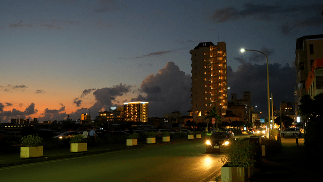 Evening city street with lit buildings
