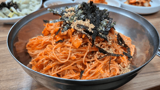Spicy bibim noodles topped with seaweed flakes