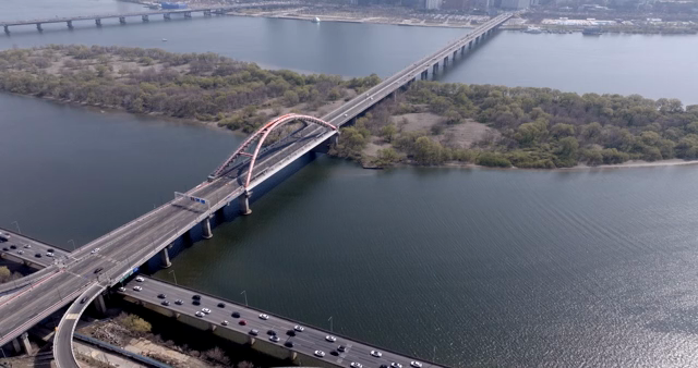 A bridge over a river with cityscape