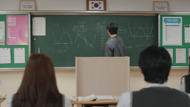 Teacher explaining math in a classroom