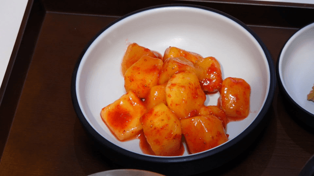 Mango slices coated with diced strawberry powder
