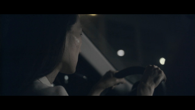 Woman driving at night in the city