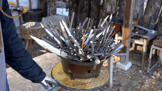 Rotating sharp wooden pencil stick in craft workshop