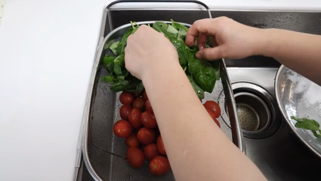 Fresh basil and tomatoes in a colander