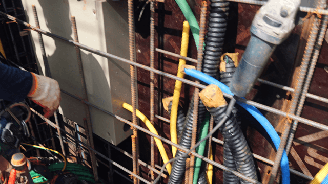 Worker handling cables at a construction site