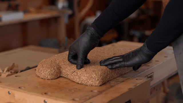 Artisan examining a cork sculpture