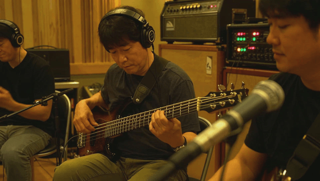 Band musicians performing instruments in studio