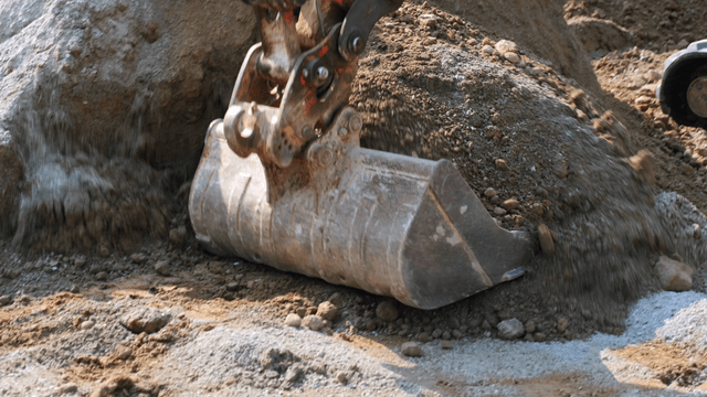 Excavator moving soil at a construction site