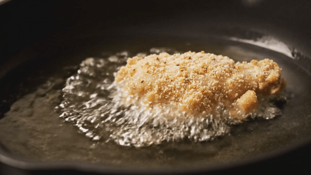 Fried chicken being cooked in hot oil