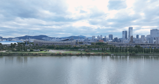 City skyline with river and stadium