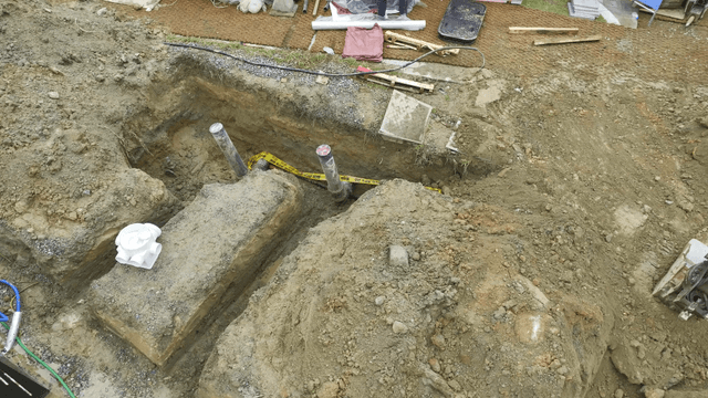 Construction site where an excavator is leveling the ground