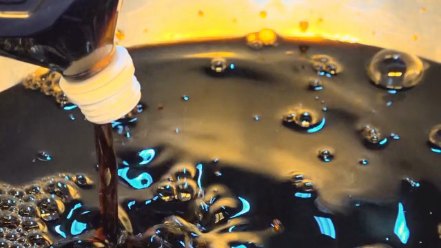 Soy sauce being poured into a large pot