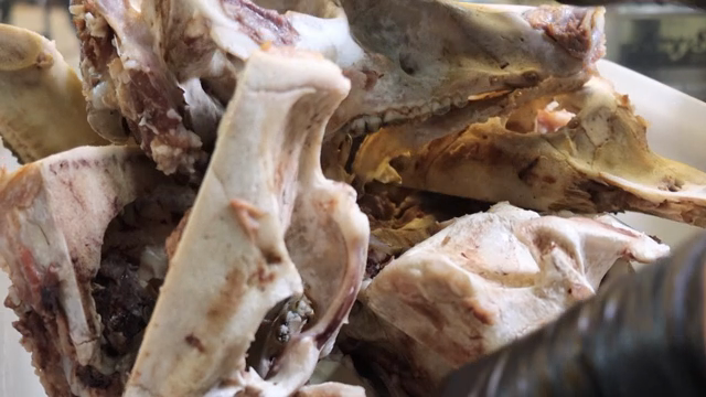 Hands preparing pork on a cutting board