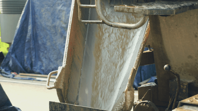 Concrete pouring from a mixer at a site