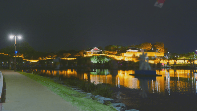 Night view of Korean fortress and pavilion with flowing river