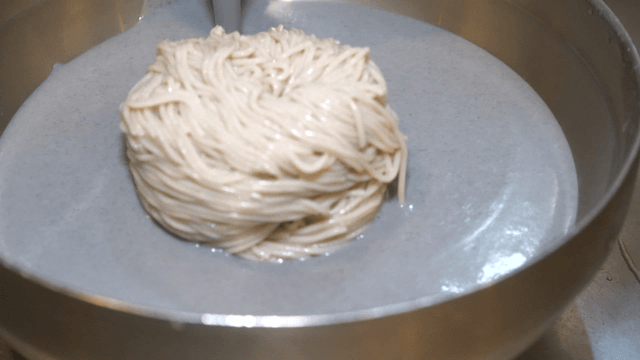 Thick black bean broth over buckwheat noodles