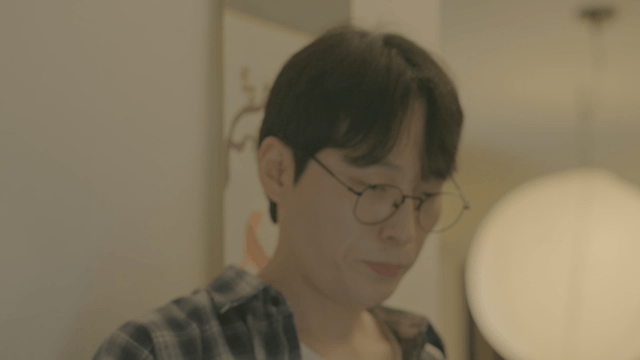 Man with glasses guiding woman to home entrance