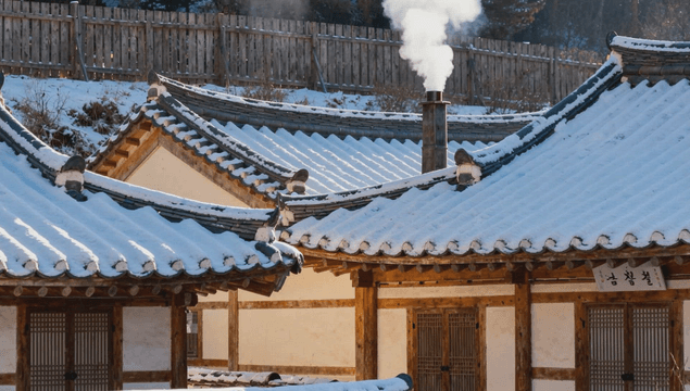 Hanok village with white smoke from chimneys