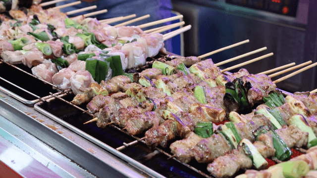 Skewers grilling at a street food stall