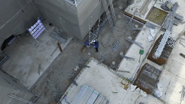 Construction workers assembling scaffolding