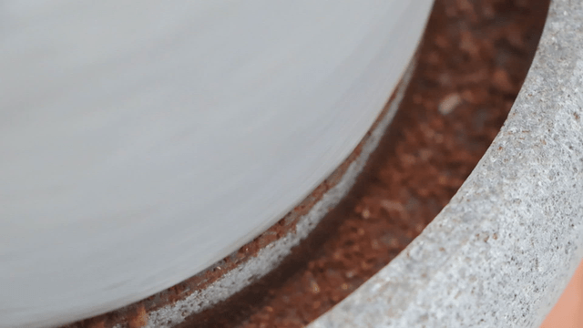 Coffee beans ground by a traditional basalt millstone