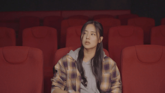 Woman sitting alone in a movie theater