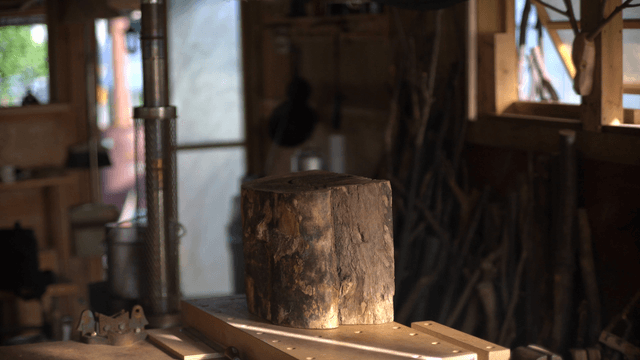 Sunlit wooden log blocks in woodworking studio