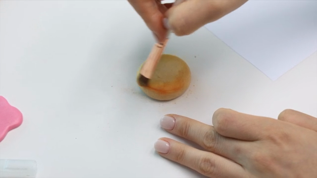 Coloring clay with a brush