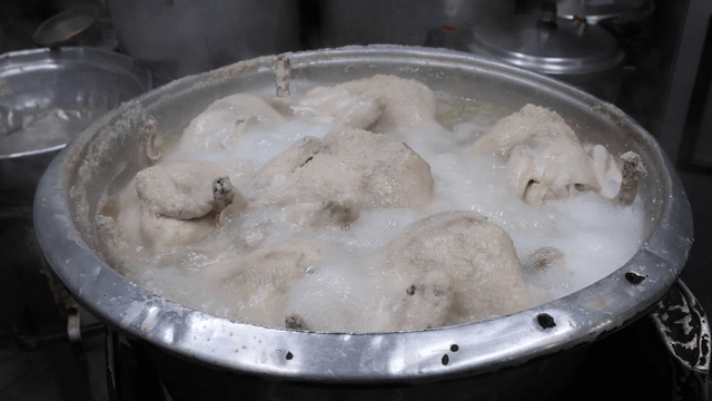 Chickens boiling in a large pot