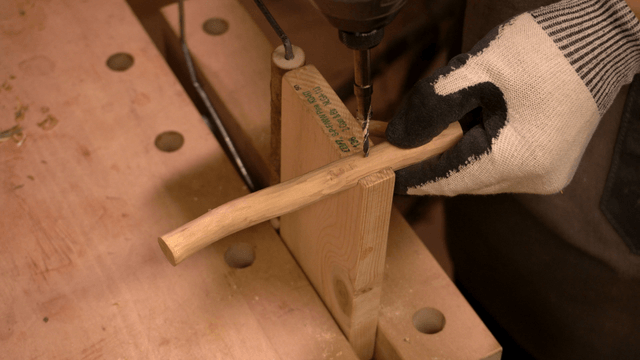 Woodcraft artisan connecting wooden pieces with a drill