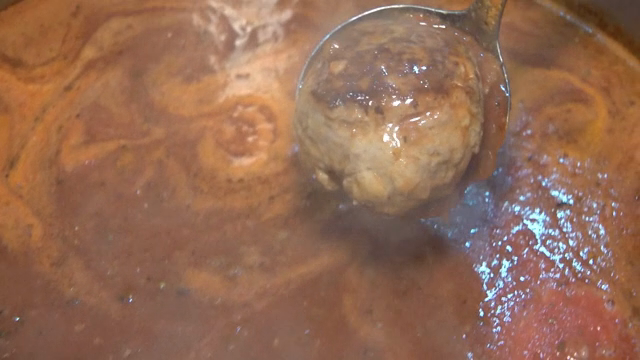 Meatball simmering in rich tomato sauce
